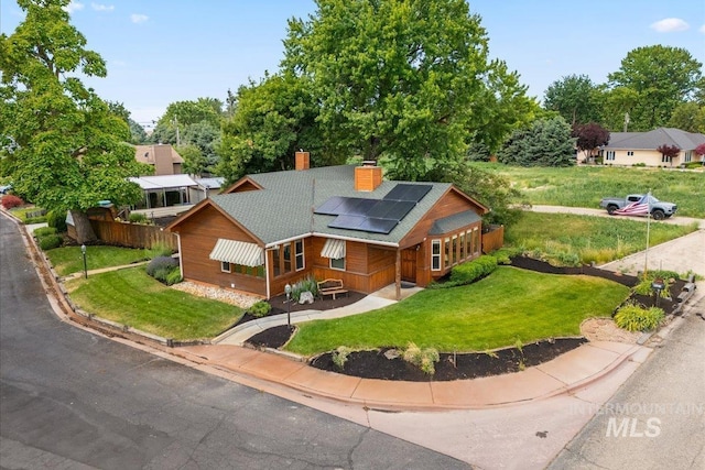 4523 N Mountain View Dr, Boise, ID 83704 - view of front of property with a chimney, roof mounted solar panels, driveway, and roof with shingles