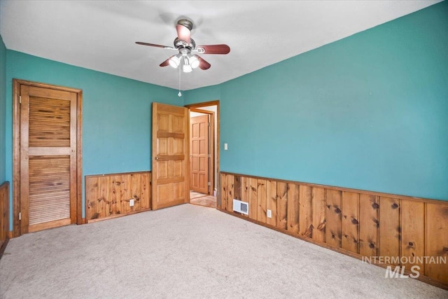 4523 N Mountain View Dr, Boise, ID 83704 - unfurnished room featuring wood walls, wainscoting, ceiling fan, and carpet