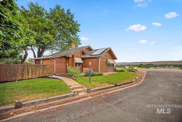4523 N Mountain View Dr, Boise, ID 83704 - view of front of house featuring a chimney and roof mounted solar panels