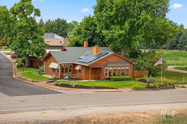 4523 N Mountain View Dr, Boise, ID 83704 - view of front facade with roof mounted solar panels and a chimney