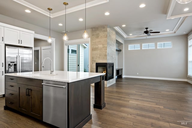 6257 N Vicenza Ln, Meridian, ID 83646 - kitchen featuring a tile fireplace, stainless steel fridge with ice dispenser, a tray ceiling, and ceiling fan