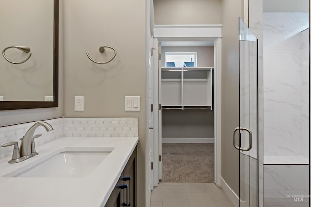 6257 N Vicenza Ln, Meridian, ID 83646 - bathroom with vanity, tasteful backsplash, tile patterned floors, and an enclosed shower