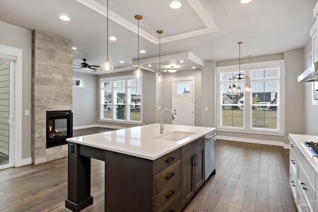 6257 N Vicenza Ln, Meridian, ID 83646 - kitchen with white cabinets, sink, ceiling fan, decorative light fixtures, and a tiled fireplace