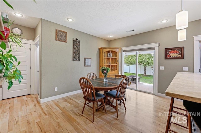 3524 Catalina Ave, Caldwell, ID 83605 - dining space with a textured ceiling, light wood-style flooring, baseboards, a textured wall, and recessed lighting