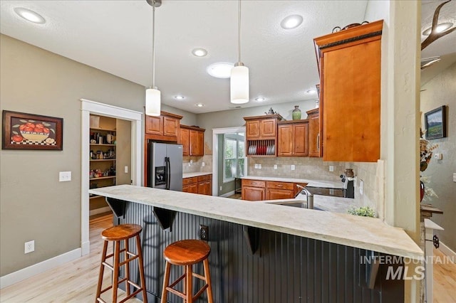 3524 Catalina Ave, Caldwell, ID 83605 - kitchen featuring stainless steel refrigerator with ice dispenser, light wood finished floors, a sink, baseboards, and recessed lighting