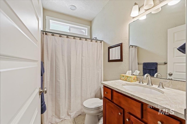 3524 Catalina Ave, Caldwell, ID 83605 - full bath featuring vanity, toilet, a textured ceiling, tile patterned flooring, and a textured wall