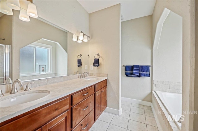 3524 Catalina Ave, Caldwell, ID 83605 - bathroom with tile patterned floors, double vanity, a garden tub, baseboards, and a shower with shower door