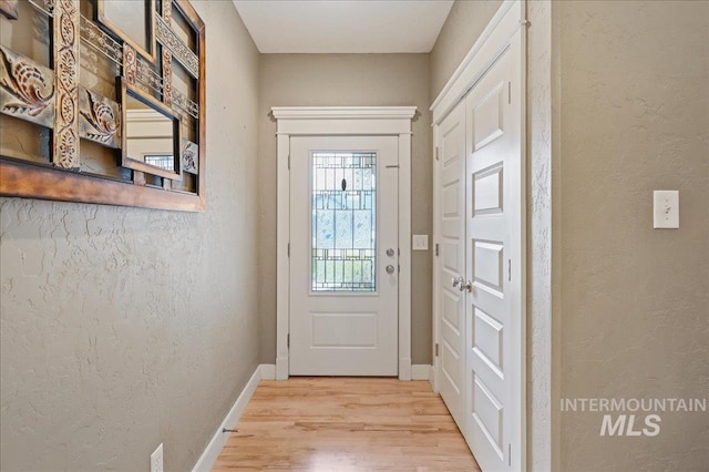 3524 Catalina Ave, Caldwell, ID 83605 - doorway featuring light wood-style floors, baseboards, and a textured wall