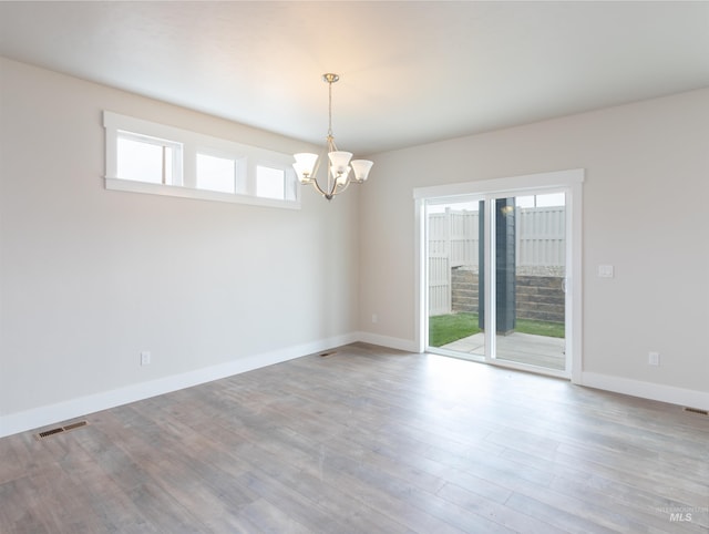 2111 W Gelding St, Middleton, ID 83644 - empty room with a chandelier, baseboards, and wood finished floors