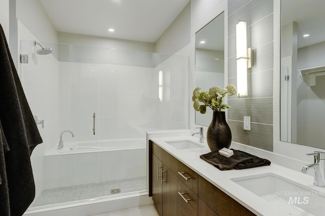 bathroom featuring vanity and independent shower and bath