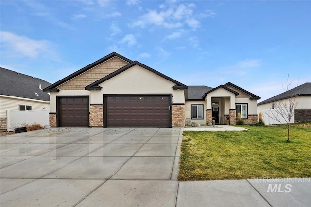 view of front of home with a garage and a front lawn