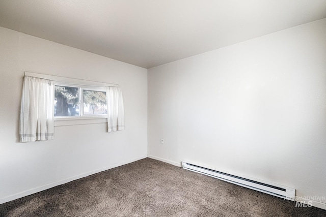 spare room with carpet flooring, a baseboard heating unit, and baseboards