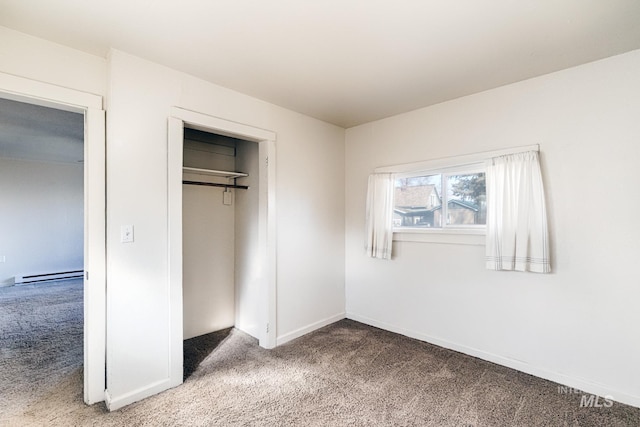 unfurnished bedroom featuring baseboards, a baseboard radiator, a closet, and light carpet