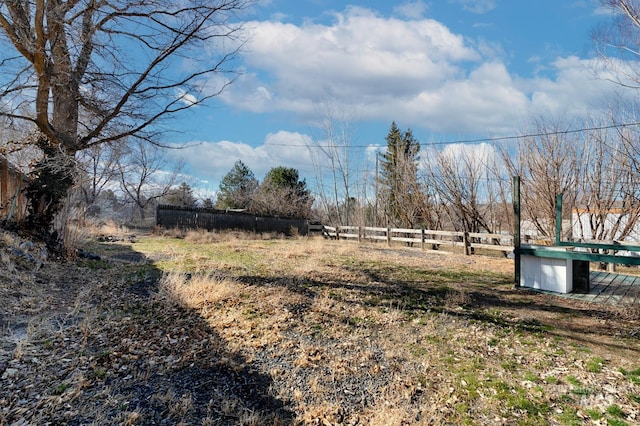 view of yard featuring a rural view and fence