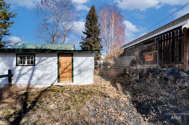 view of outbuilding with fence