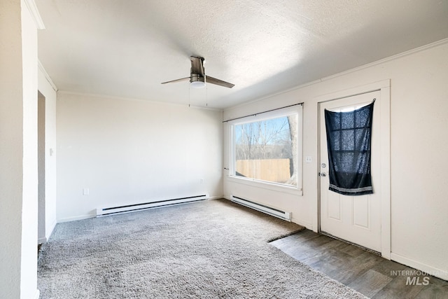 foyer with a baseboard radiator, a textured ceiling, wood finished floors, and a ceiling fan