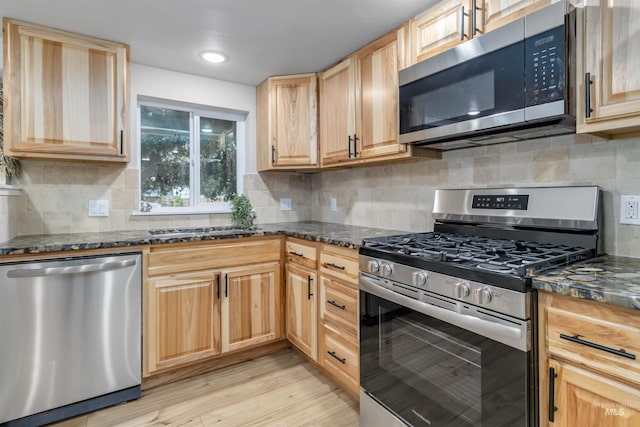 1010 E Main St, Weiser, ID 83672 - kitchen featuring stainless steel appliances, light brown cabinets, light wood-style flooring, and backsplash
