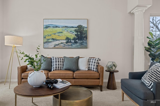 living room featuring decorative columns and light carpet