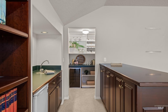 bar with refrigerator, lofted ceiling, beverage cooler, light colored carpet, and dark brown cabinetry