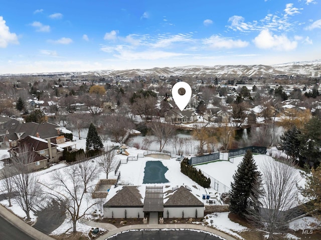 snowy aerial view with a mountain view