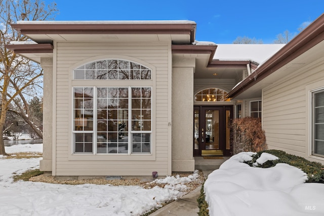 view of snow covered property entrance