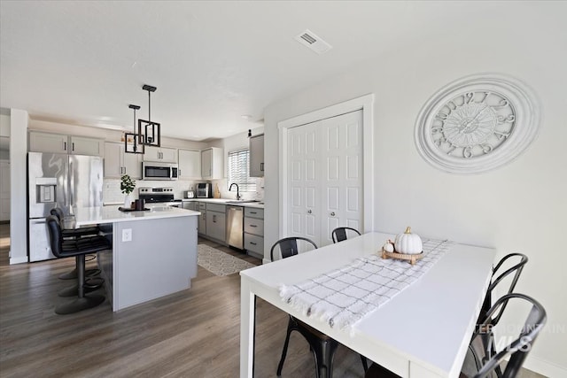 dining area with visible vents and dark wood-style floors