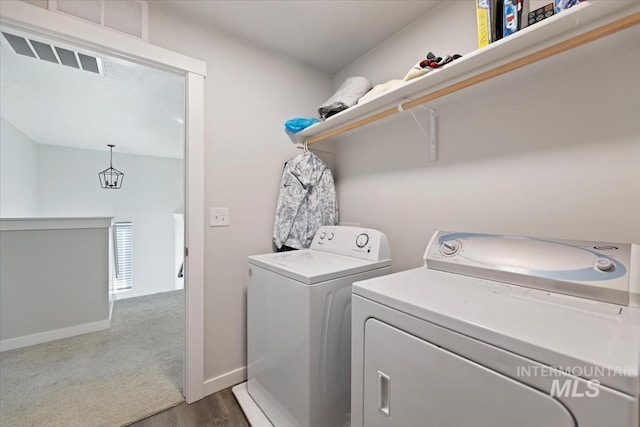 laundry room featuring washer and clothes dryer, laundry area, baseboards, and dark colored carpet