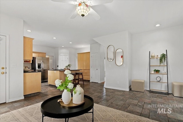2021 W Ardell Rd, Kuna, ID 83634 - living room with ceiling fan, stone tile floors, baseboards, and recessed lighting