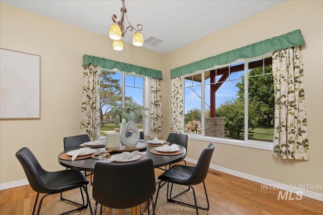 2021 W Ardell Rd, Kuna, ID 83634 - dining space with a chandelier, baseboards, and wood finished floors