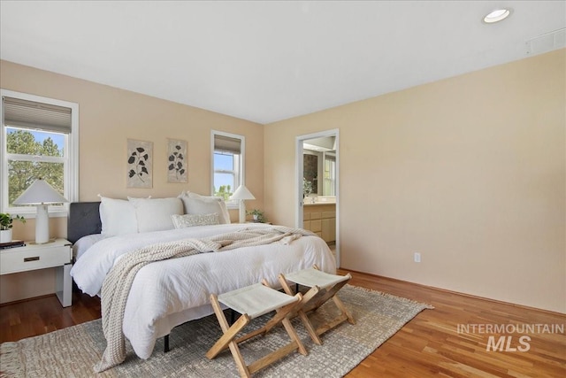 2021 W Ardell Rd, Kuna, ID 83634 - bedroom with multiple windows, wood finished floors, recessed lighting, and connected bathroom