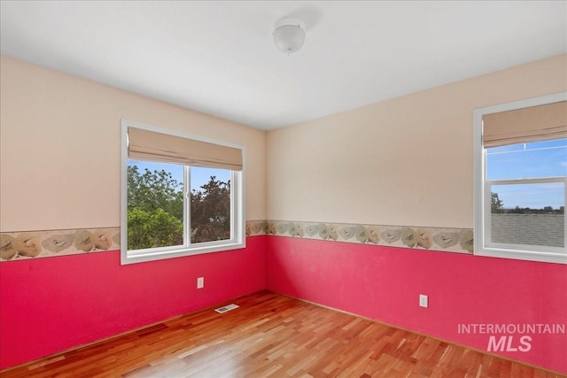 2021 W Ardell Rd, Kuna, ID 83634 - unfurnished room featuring light wood-style floors and a wainscoted wall