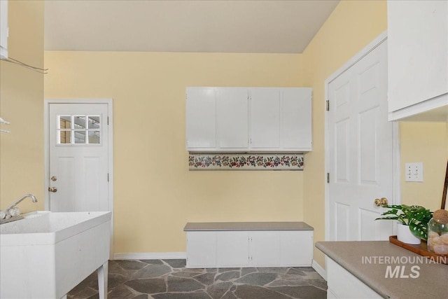 2021 W Ardell Rd, Kuna, ID 83634 - mudroom with baseboards, a sink, and dark stone finish flooring