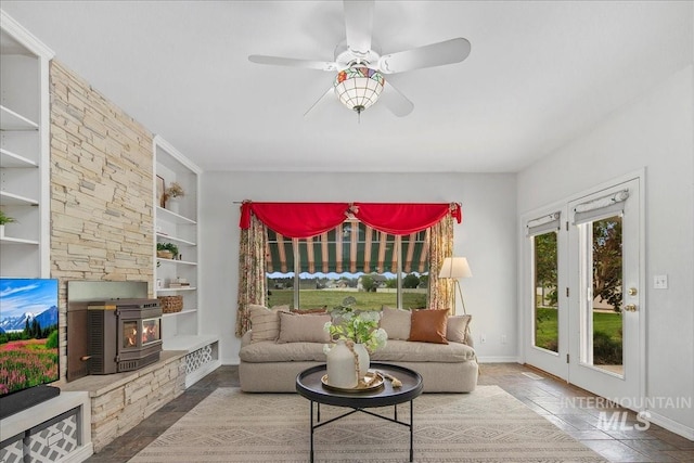 2021 W Ardell Rd, Kuna, ID 83634 - living area with a ceiling fan, baseboards, built in features, and a wood stove