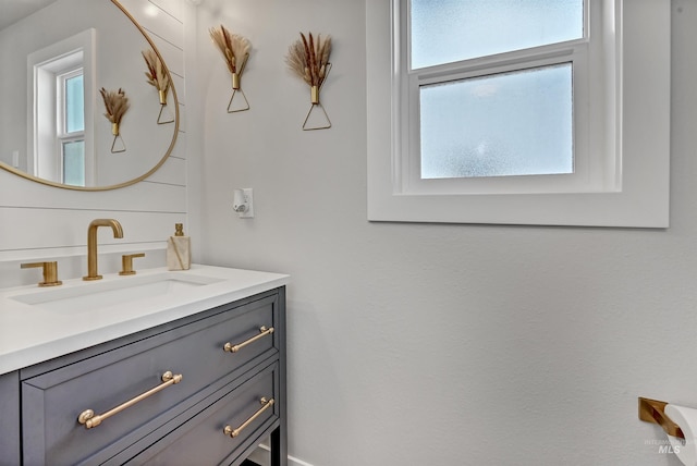 bathroom with plenty of natural light and vanity