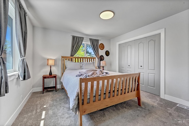 bedroom with carpet flooring, a closet, and baseboards
