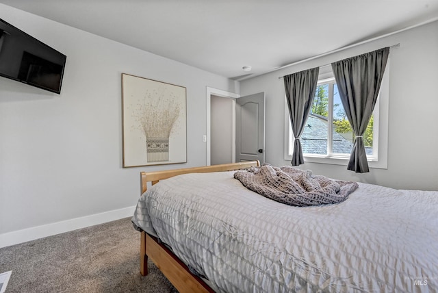 carpeted bedroom featuring baseboards