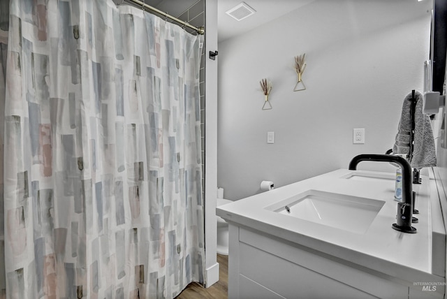 full bathroom with wood finished floors, a shower with shower curtain, and vanity