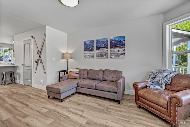 living area with light wood finished floors and baseboards