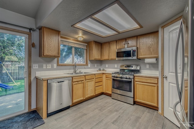 2209 S Plateau Dr, Nampa, ID 83686 - kitchen with appliances with stainless steel finishes, light wood finished floors, light countertops, and healthy amount of natural light