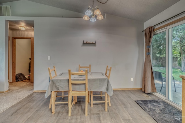 2209 S Plateau Dr, Nampa, ID 83686 - dining room featuring vaulted ceiling, wood finished floors, and a chandelier