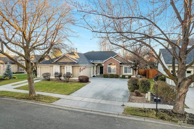 ranch-style home with a front yard and a garage