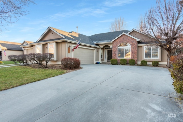 single story home featuring a garage and a front lawn