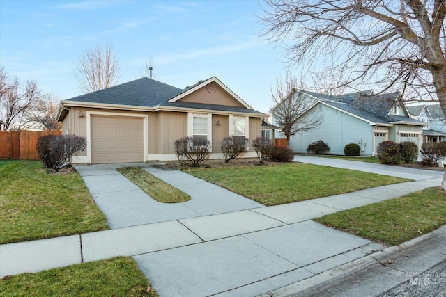 ranch-style house featuring a garage and a front lawn