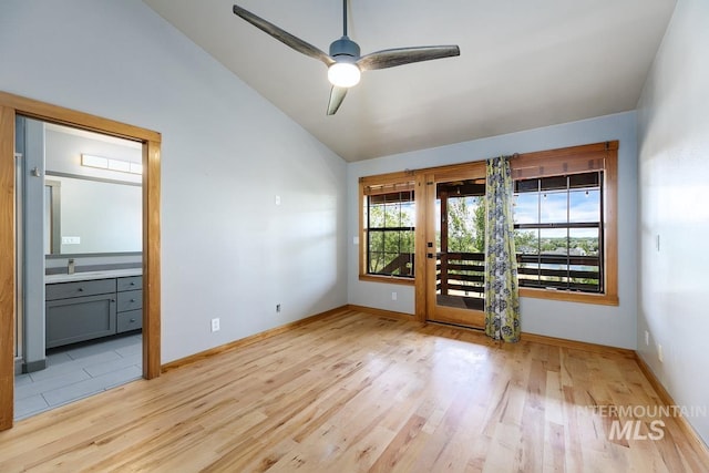 8315 Elk Ridge Ln, Middleton, ID 83644 - spare room featuring lofted ceiling, light wood-style floors, baseboards, a ceiling fan, and a sink