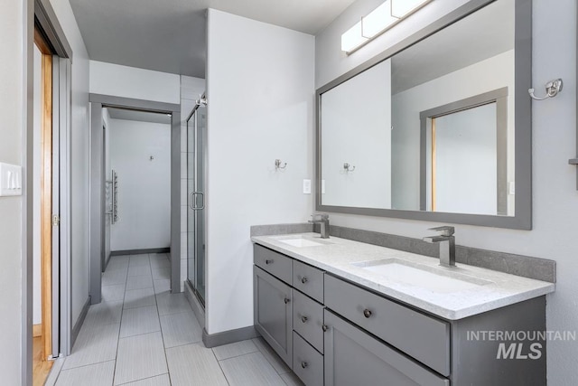 8315 Elk Ridge Ln, Middleton, ID 83644 - full bathroom featuring double vanity, a stall shower, tile patterned flooring, and baseboards