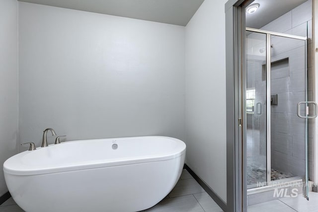 8315 Elk Ridge Ln, Middleton, ID 83644 - bathroom featuring a soaking tub, tile patterned floors, a stall shower, and baseboards