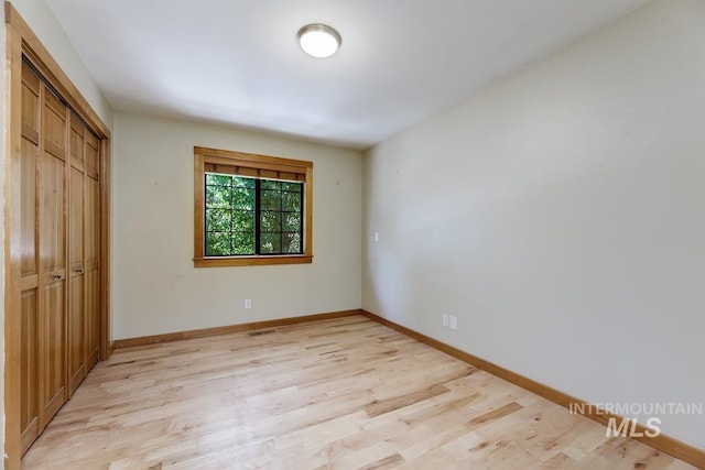 8315 Elk Ridge Ln, Middleton, ID 83644 - unfurnished bedroom featuring light wood-type flooring, a closet, and baseboards