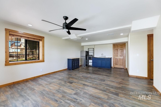 8315 Elk Ridge Ln, Middleton, ID 83644 - unfurnished living room featuring baseboards, a sink, dark wood-style flooring, ceiling fan, and recessed lighting