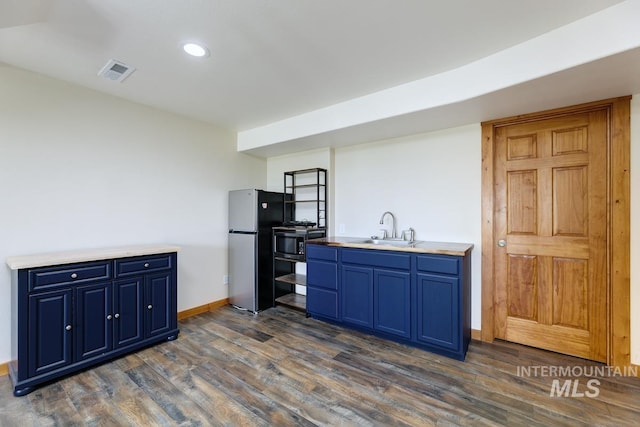 8315 Elk Ridge Ln, Middleton, ID 83644 - kitchen with blue cabinetry, a sink, stainless steel appliances, dark wood-type flooring, and recessed lighting