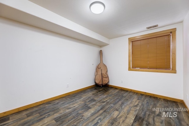 8315 Elk Ridge Ln, Middleton, ID 83644 - spare room with baseboards and dark wood-style floors
